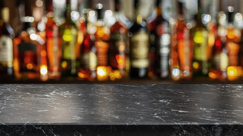 Marble bar top with bottles in background