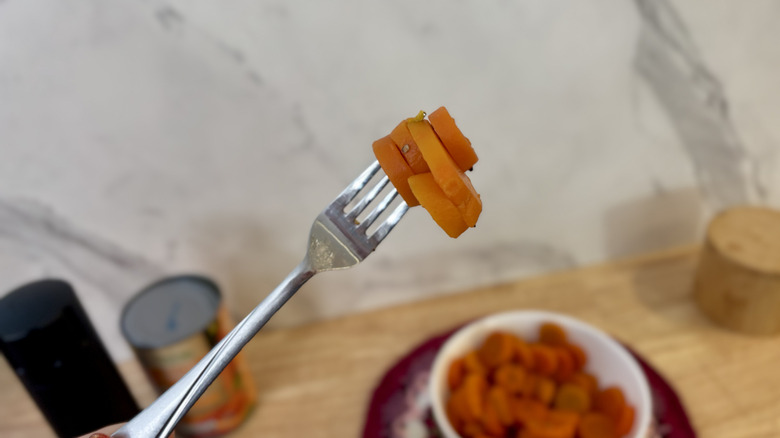 holding up fork of carrots