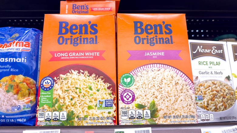 Various brands of boxed rice on a grocery store shelf