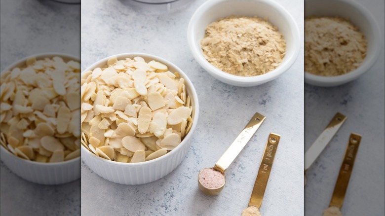 Almonds and nutritional yeast in ramekins to make vegan parmesan