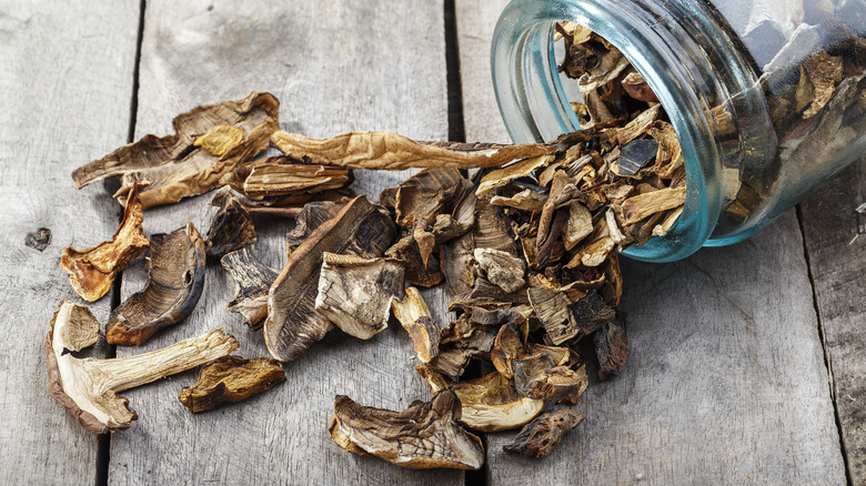 Dried mushrooms spilling out of jar