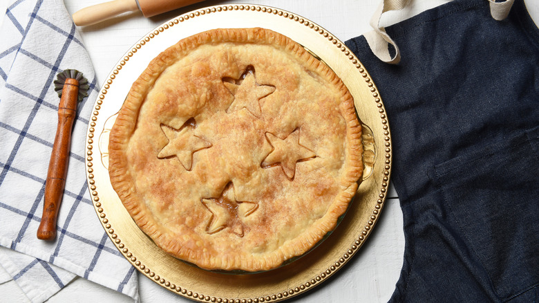 A completed pie is taken out from the oven to be served.