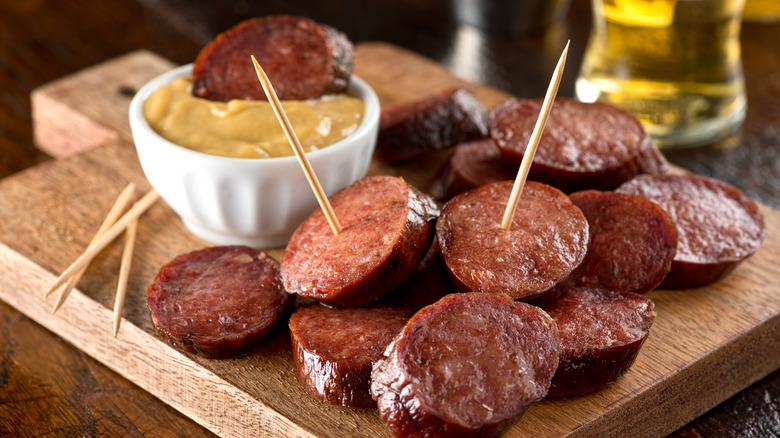 Beer mustard with fried sausage slices