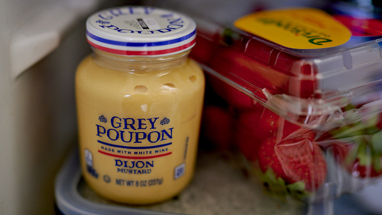 Grey Poupon Dijon mustard in refrigerator