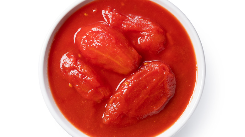 Whole canned tomatoes white background