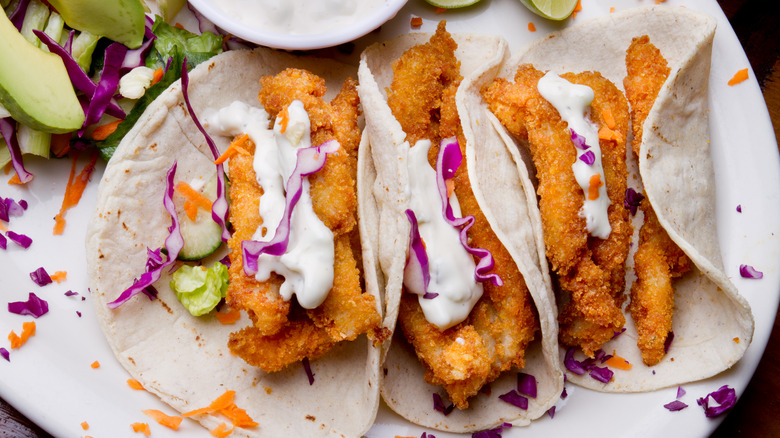 Fried fish tacos with limes and cabbage