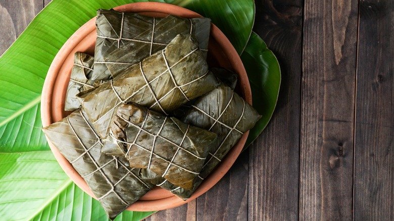 tamales wrapped in banana leaves
