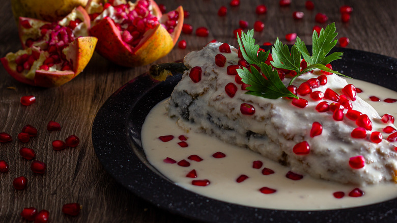 Chiles en nogada with pomegranate seeds