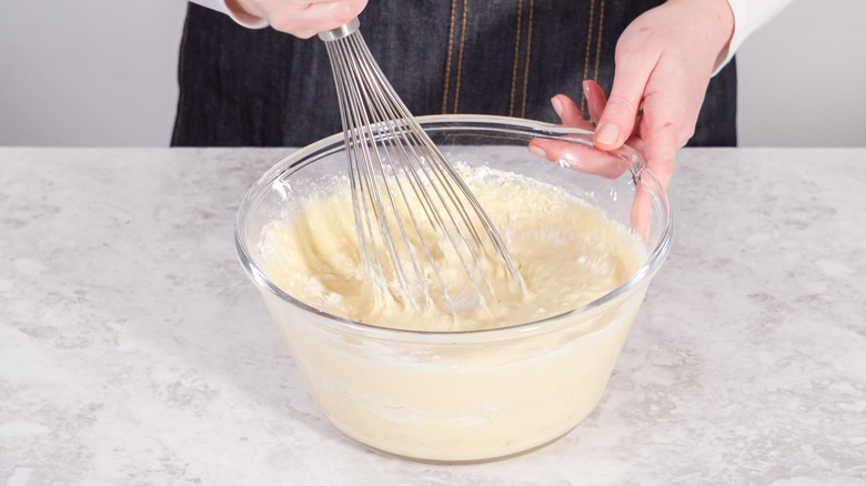 hands mixing pancake batter