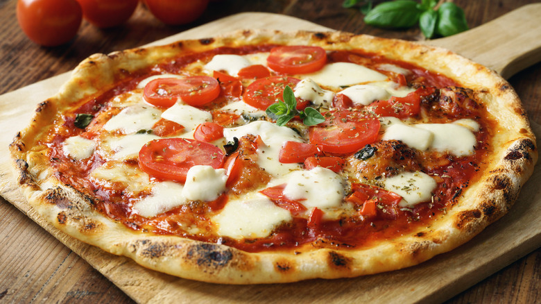 A pizza on wooden board