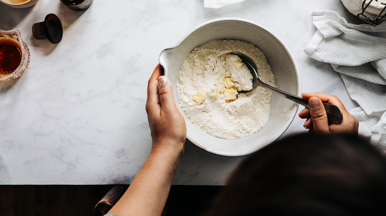 stirring butter into flour