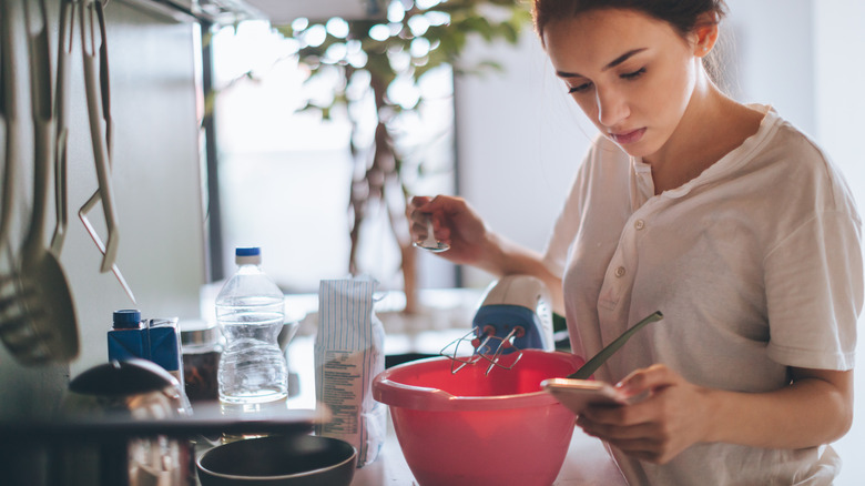 woman reading recipe on her phone