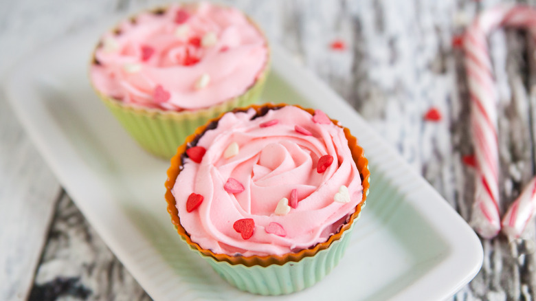 Cupcakes topped with pink marshmallow creme frosting