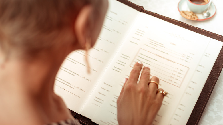 Woman reading restaurant menu
