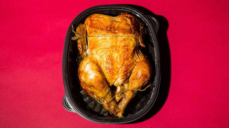 Rotisserie chicken against red background