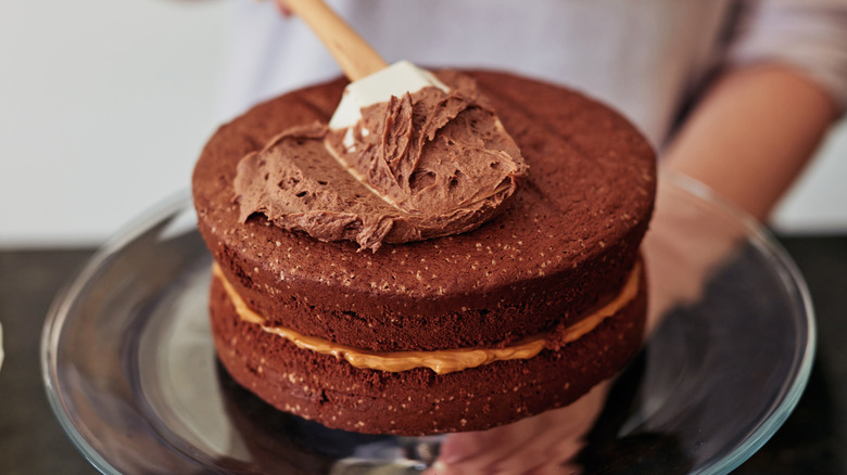 Chocolate cake being frosted