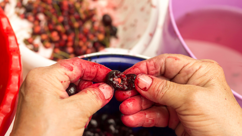 Removing cherry pits by hand