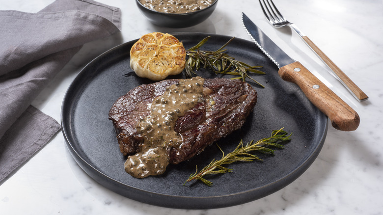 Steak with garlic, herbs, and sauce