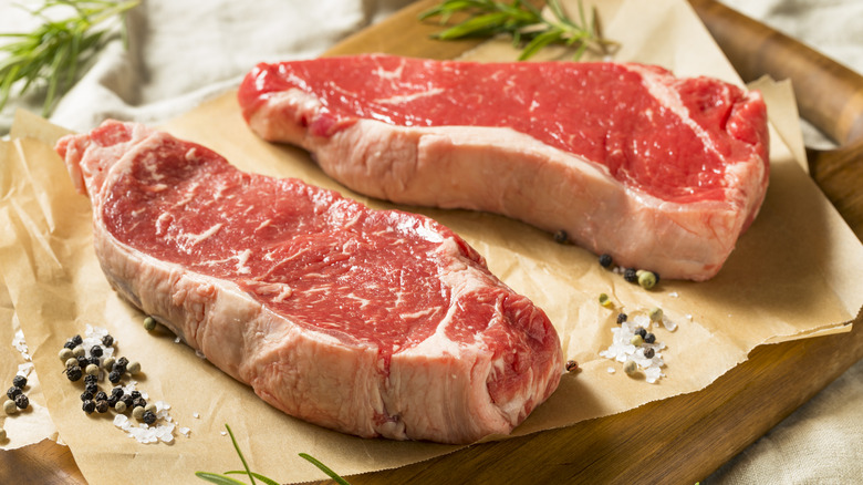 Raw thick cut New York strip steaks