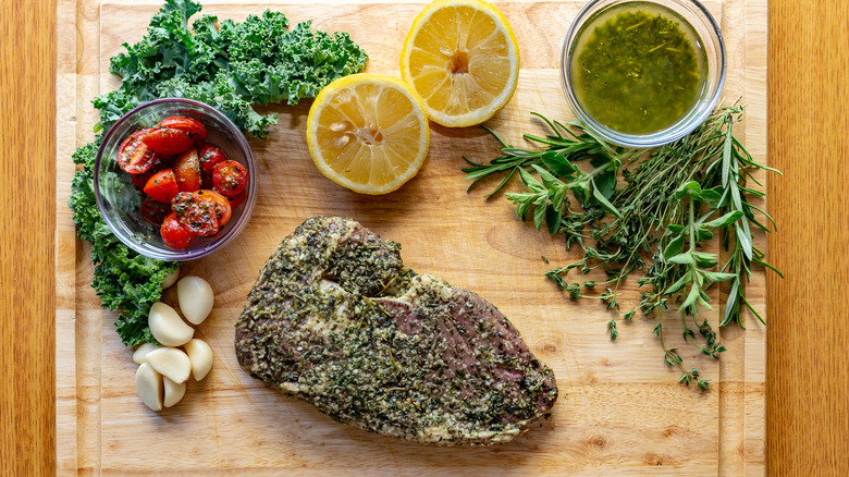 Ribeye steak with herb crust on cutting board