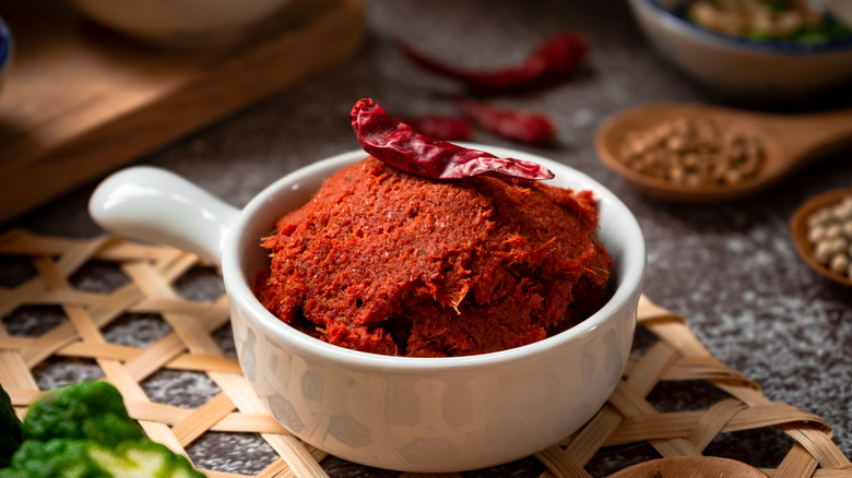 Thai red curry paste in white bowl
