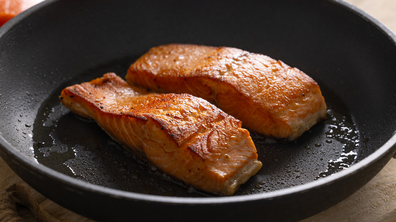 Crisp salmon fillets in a hot pan