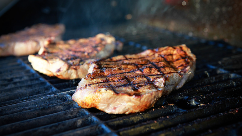 Ribeyes with grill marks on a hot grill