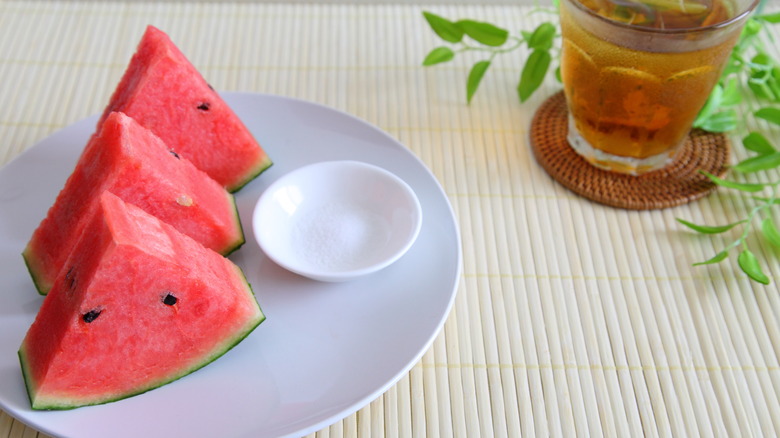 Watermelon slices on plate with dish of salt