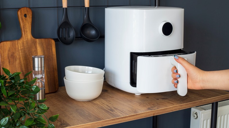 white air fryer on wood counter