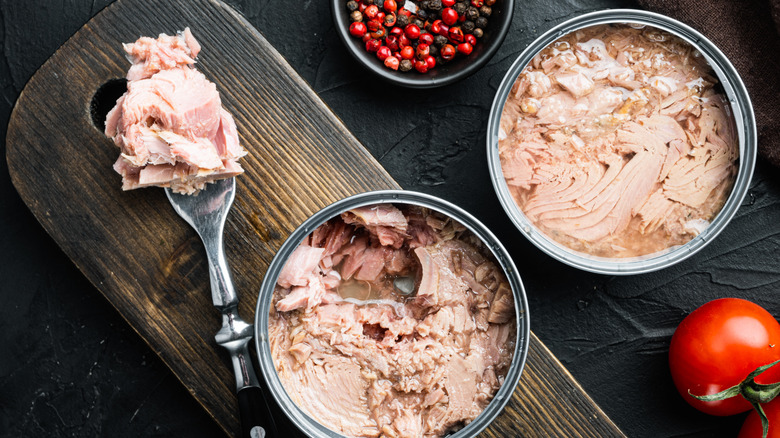 Open cans of tuna showing flaky texture