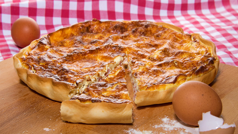 Quiche Lorraine with eggs on a red checkered tablecloth