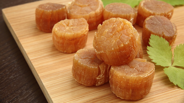 dried scallops on a wooden cutting board