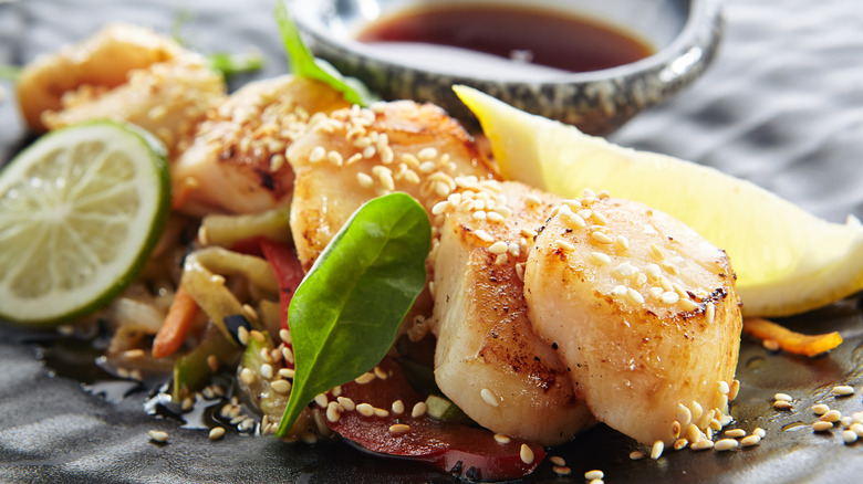 Japanese-style scallops with sesame seed garnish