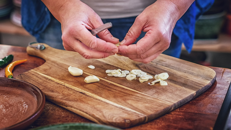 Person slicing garlic