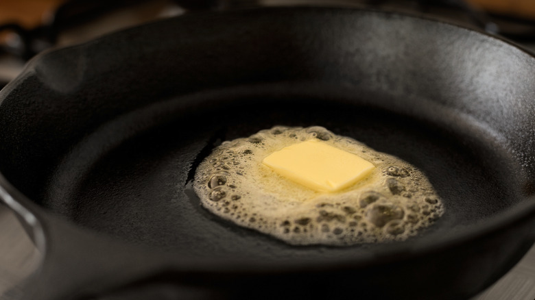 Closeup of melted butter in a cast iron skillet