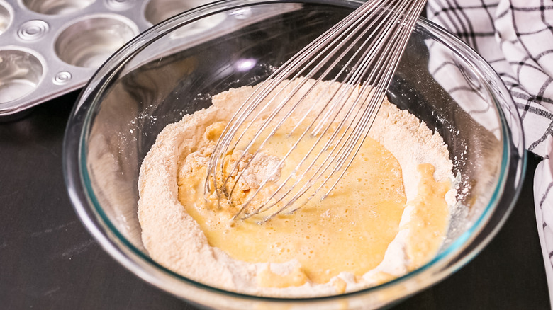 Bowl of cornbread mix and a whisk