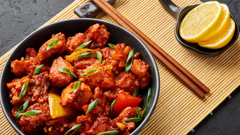 Bowl of fried salmon bites with bell peppers