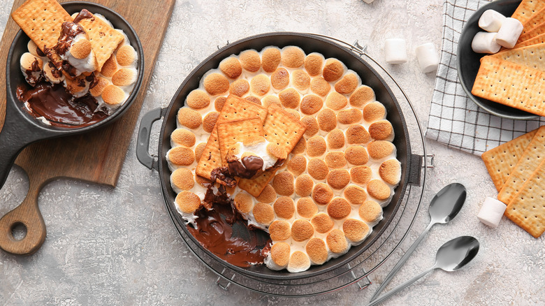 Overhead shot of s'mores dip surrounded by marshmallows and crackers