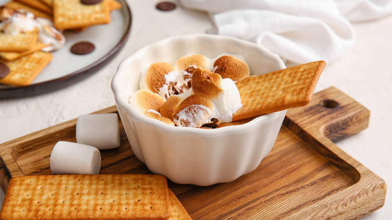 Ramekin with s'mores dip and crackers on serving tray