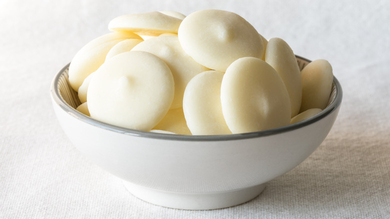 solid white chocolate discs in small white bowl