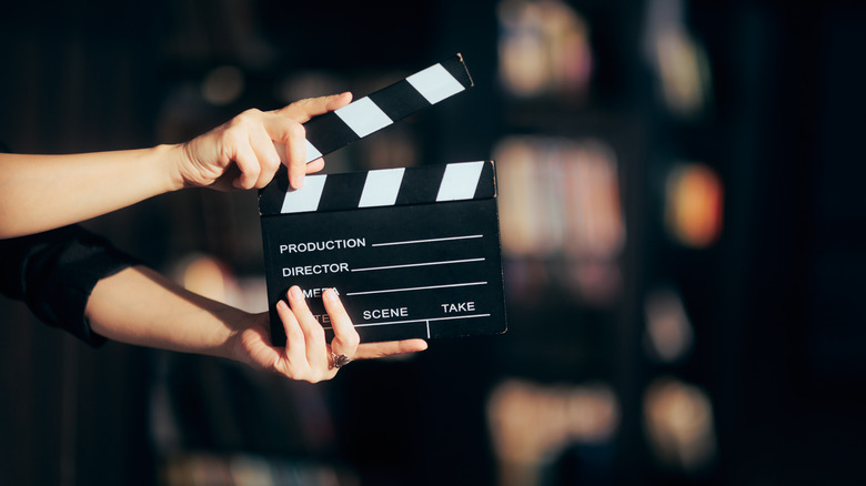 Person holding a film clapboard