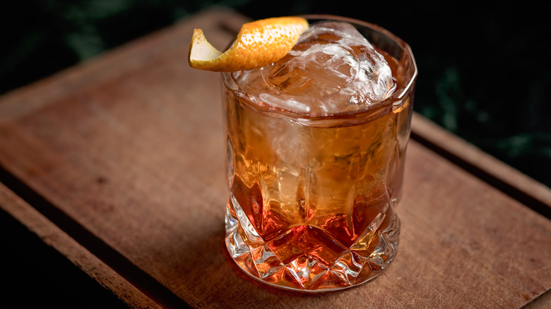 old fashioned cocktail on wooden board