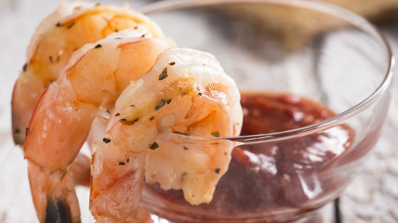 shrimp placed on glass with sauce