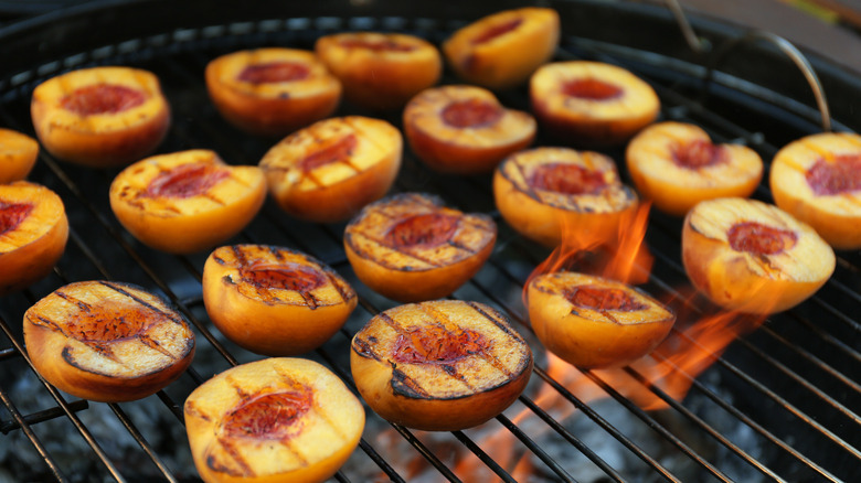 Grilling peaches on a charcoal grill