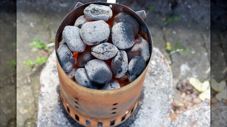 Glowing charcoal in a chimney starter