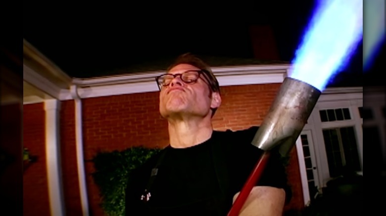 Alton Brown with a giant torch