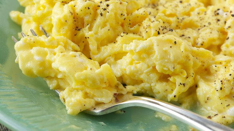 creamy scrambled eggs with fork