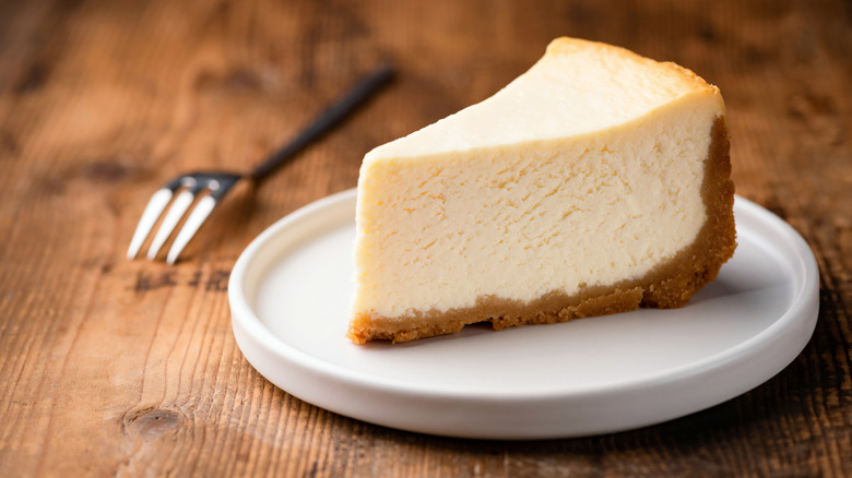 Slice of New York style cheesecake on plate