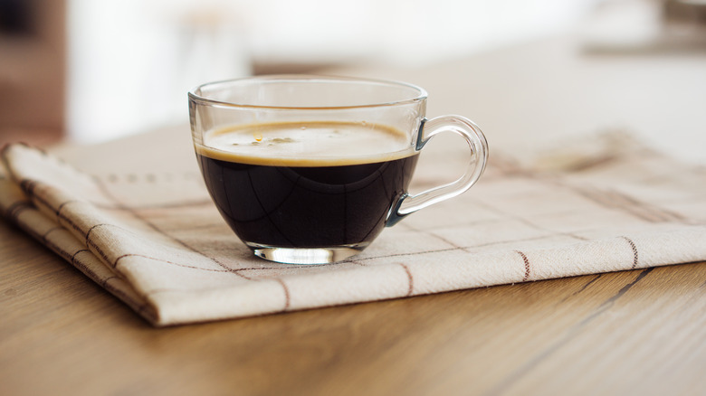 An americano in a glass mug