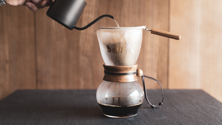 Person making drip coffee